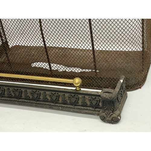 520 - A Victorian fire guard and a Victorian cast iron and brass fender.