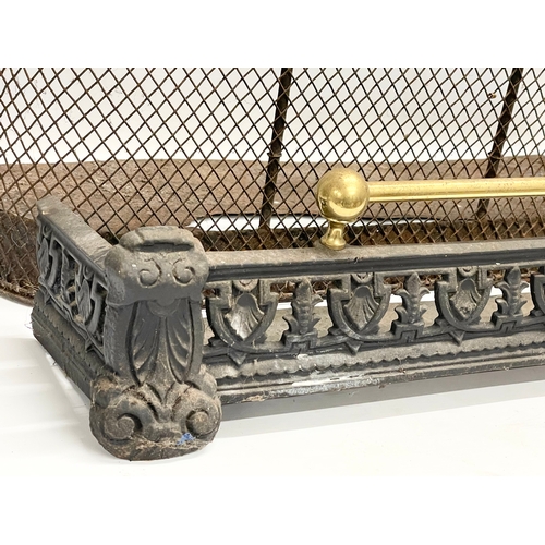 520 - A Victorian fire guard and a Victorian cast iron and brass fender.