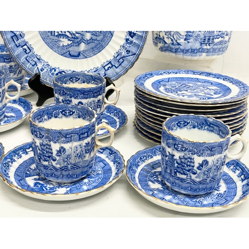 701 - A 35 piece late 19th century Paragon Willow Pattern porcelain tea set.