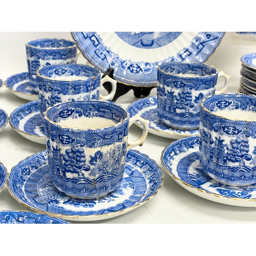 701 - A 35 piece late 19th century Paragon Willow Pattern porcelain tea set.