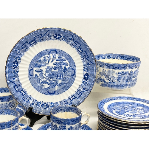 701 - A 35 piece late 19th century Paragon Willow Pattern porcelain tea set.