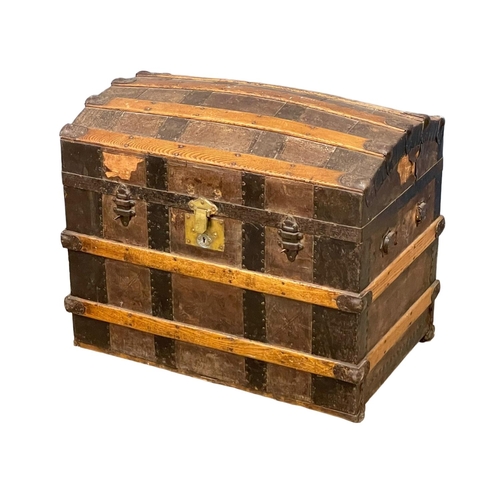 521R - An early 20th century dome top trunk. 73x49x60cm