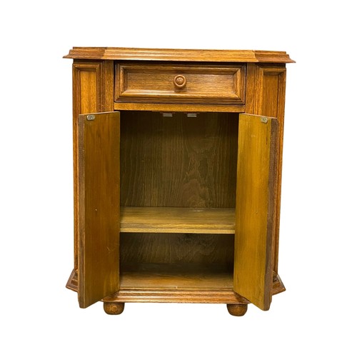 521Q - A small oak side cabinet with drawer. 67x29.5x74cm.