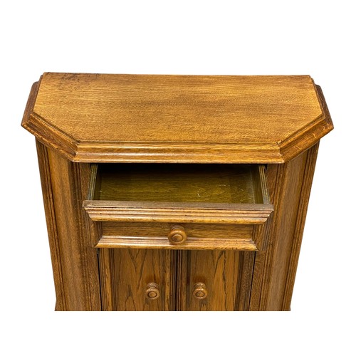 521Q - A small oak side cabinet with drawer. 67x29.5x74cm.