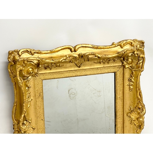 521V - A Victorian ornate gilt framed mirror. 60x8x65cm