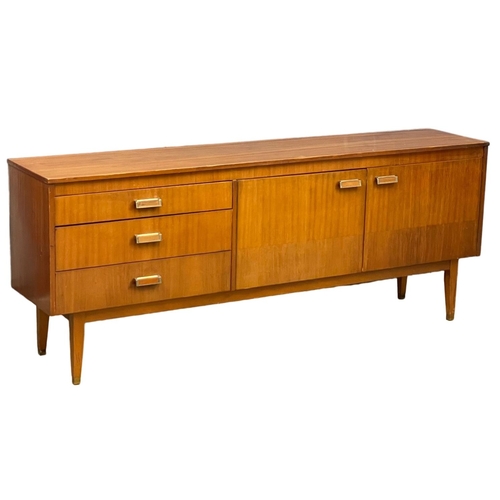 124 - A Mid Century teak sideboard. 185.5x39x74cm