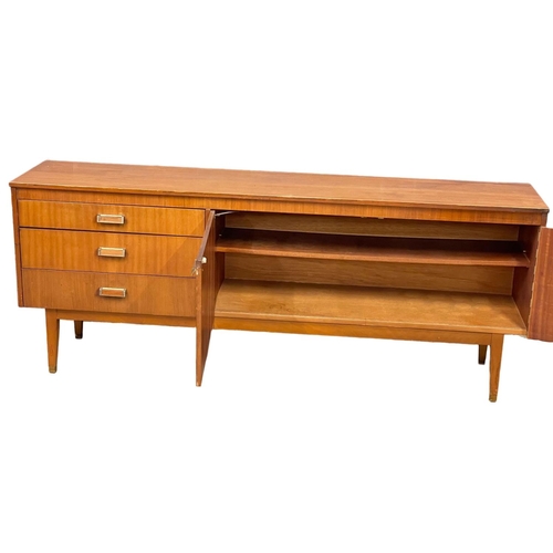 124 - A Mid Century teak sideboard. 185.5x39x74cm