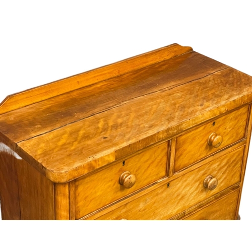 242 - A Victorian Satin Birch gallery back chest of drawers on bun feet. 106x45x95cm.