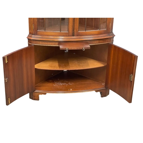 253 - A large Georgian style mahogany corner cabinet with brushing slide. 89x188cm