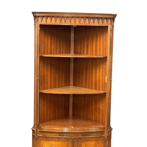 253 - A large Georgian style mahogany corner cabinet with brushing slide. 89x188cm