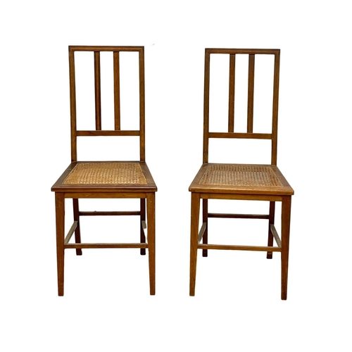 254 - A pair of inlaid mahogany side chairs with bergere seats.