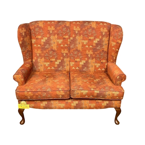 379 - A vintage wingback sofa by Sherborne. 132cm