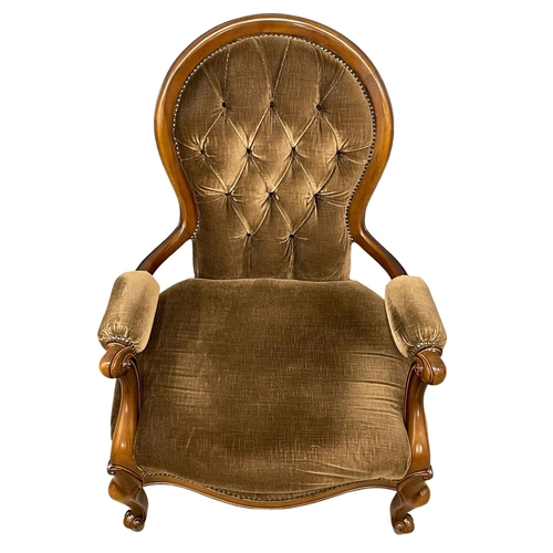 39 - A Victorian style deep button armchair on cabriole legs.