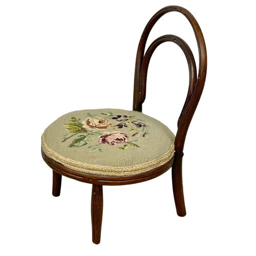 87 - An early 20th century child’s Bentwood chair with tapestry seat.