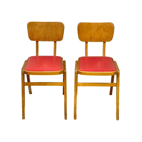 88 - A pair of vintage beech stacking chairs with vinyl seats