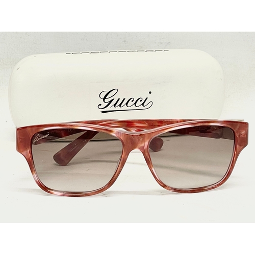 797 - A pair of ladies Gucci sunglasses in case.