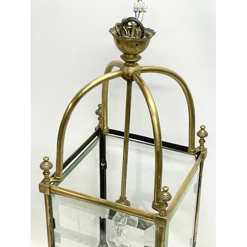 5 - A large late 19th/ early 20th century heavy brass electrified lantern with bevelled glass panels. 27... 