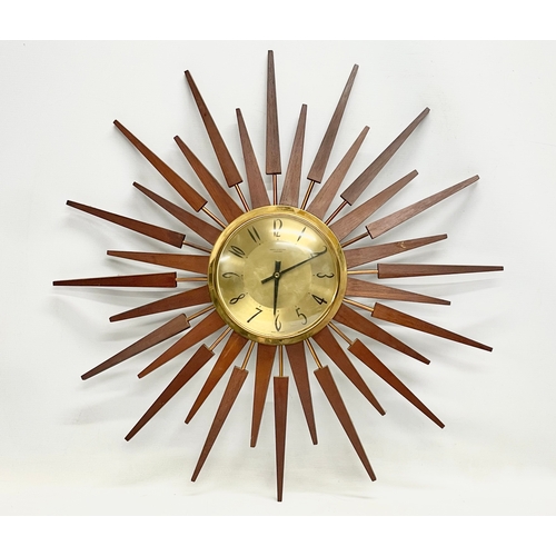 10 - A large 1960’s Mid Century teak sunburst clock by Anstey & Wilson. 62.5cm