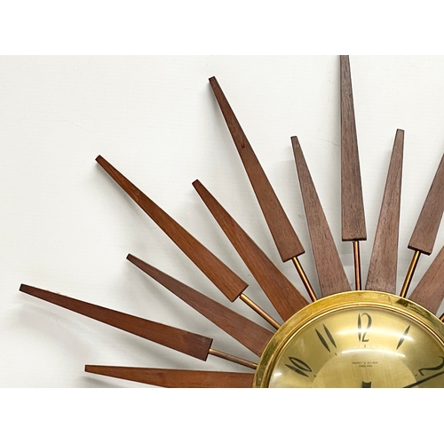 10 - A large 1960’s Mid Century teak sunburst clock by Anstey & Wilson. 62.5cm