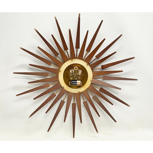 10 - A large 1960’s Mid Century teak sunburst clock by Anstey & Wilson. 62.5cm