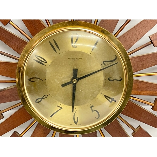 10 - A large 1960’s Mid Century teak sunburst clock by Anstey & Wilson. 62.5cm