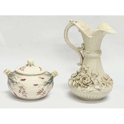 849 - A 1st period Belleek Pottery Grass Pattern sugar bowl with lid and a 2nd period Belleek Pottery jug.... 