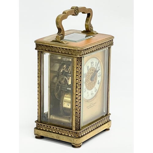 12 - A 19th century ornate brass carriage clock by Walter Wyatt. With key. 8x6x14cm including handle.