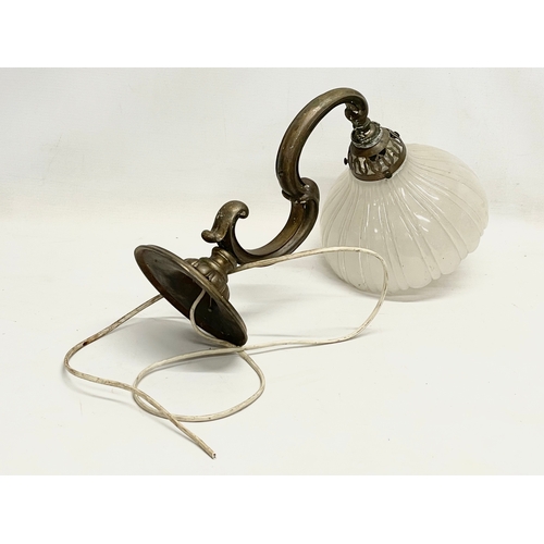 38 - A vintage brass wall lighting fitting with glass shade. 36cm