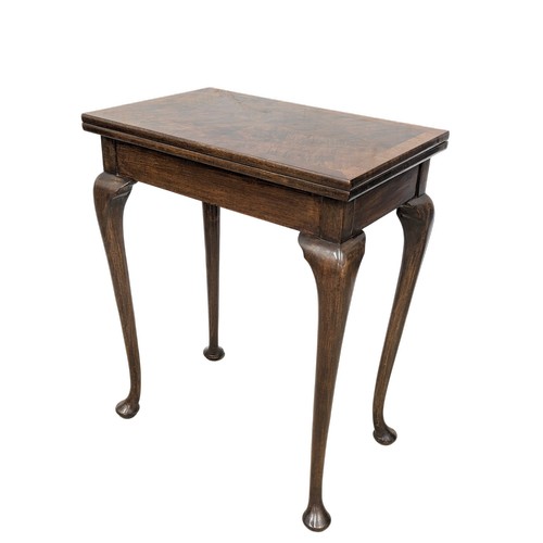 1623 - An early 20th century mahogany games table on Cabriole legs, 61cm x 38cm x 76cm