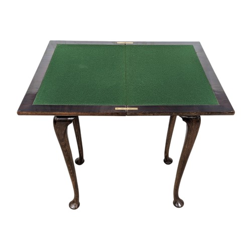 1623 - An early 20th century mahogany games table on Cabriole legs, 61cm x 38cm x 76cm