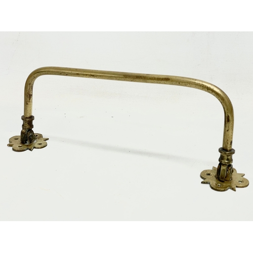 48 - A quantity of 19th and early 20th century brass candleholders, rails and hooks.