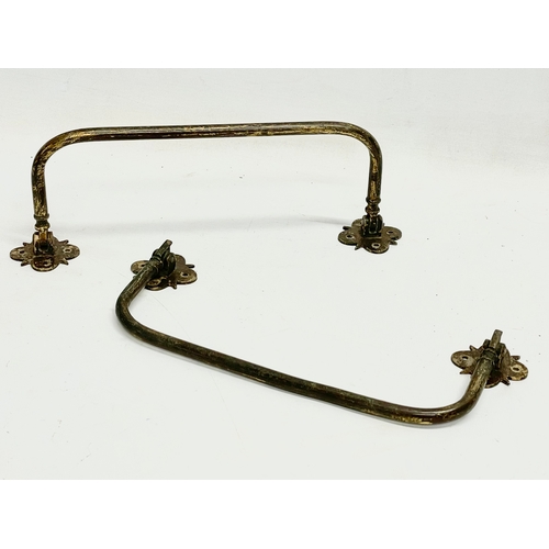 48 - A quantity of 19th and early 20th century brass candleholders, rails and hooks.