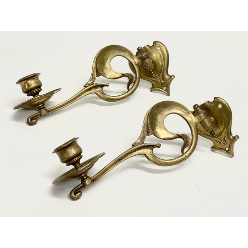 48 - A quantity of 19th and early 20th century brass candleholders, rails and hooks.