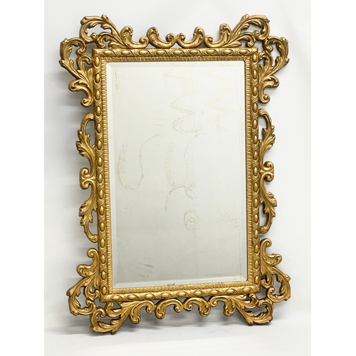 257 - A vintage ornate gilt framed mirror. 61x84cm