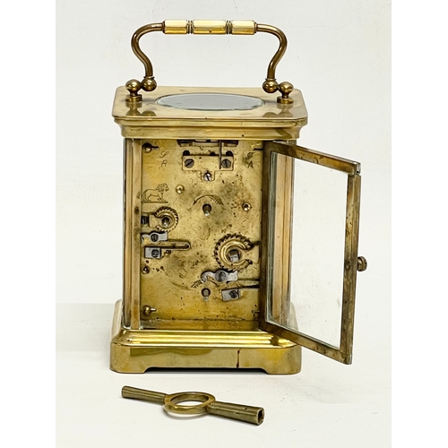 168 - A late 19th century brass carriage clock with key