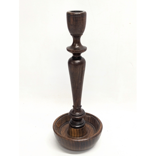 844 - A pair of early 20th century oak candlesticks. 27.5cm