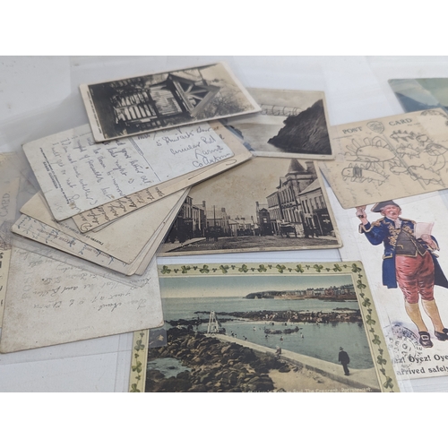 69 - A quantity of early 20th century postcards, including some dating 1959.