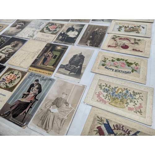 70 - A quantity of vintage postcards including World War I embroidered postcards.