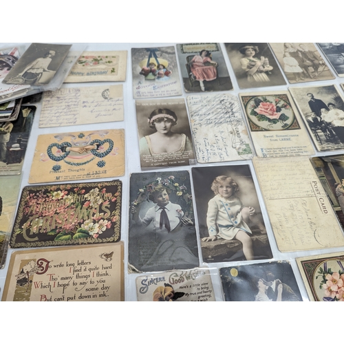 70 - A quantity of vintage postcards including World War I embroidered postcards.