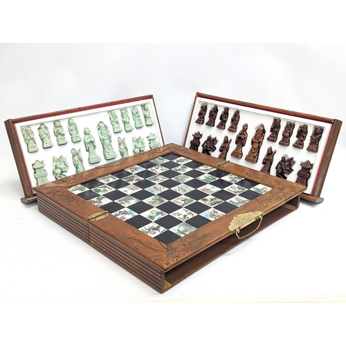 842 - A Japanese style chess set. Complete. Case measures 45.5x22.5x12.5cm