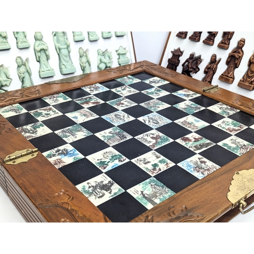 842 - A Japanese style chess set. Complete. Case measures 45.5x22.5x12.5cm