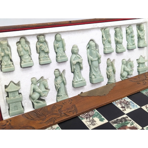 842 - A Japanese style chess set. Complete. Case measures 45.5x22.5x12.5cm