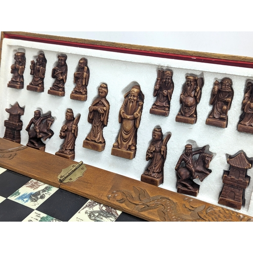 842 - A Japanese style chess set. Complete. Case measures 45.5x22.5x12.5cm