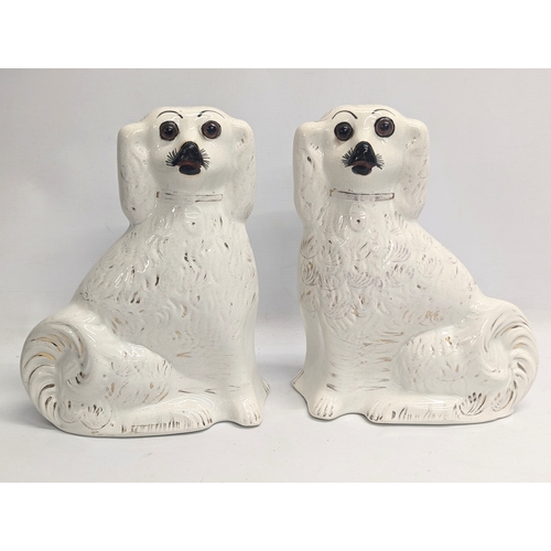 829 - A pair of Victorian Staffordshire pottery dogs. 27.5cm