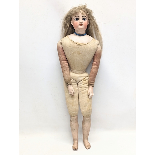 22 - A late 19th / early 20th century Gesland doll with bisque head. 56cm