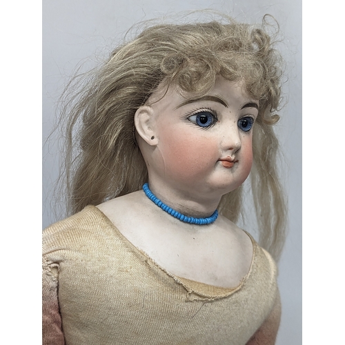 22 - A late 19th / early 20th century Gesland doll with bisque head. 56cm