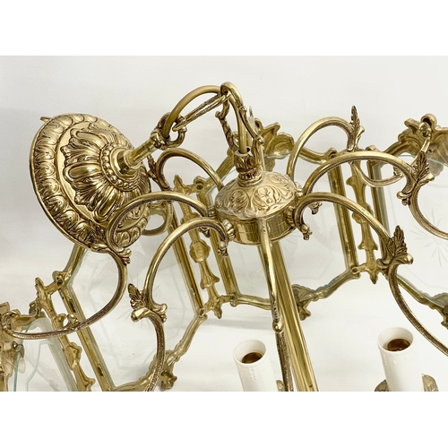 91 - A large ornate brass light fitting with etched glass panels. 46x69cm