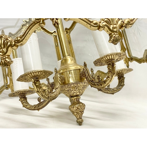 91 - A large ornate brass light fitting with etched glass panels. 46x69cm