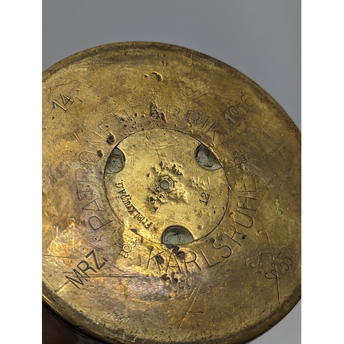 184 - A World War I German Trench Art brass jug, with 3 World War II shells, dated 1942 and 1943.