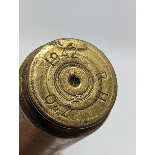 184 - A World War I German Trench Art brass jug, with 3 World War II shells, dated 1942 and 1943.